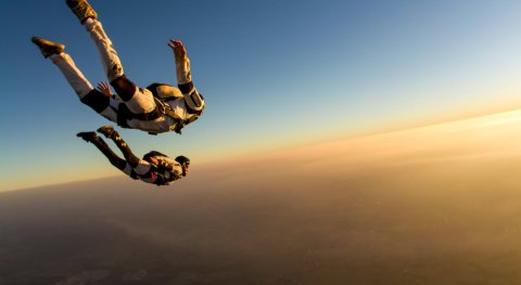 Will a heavier body achieve a higher free-fall velocity than a lighter one (of the same size)?