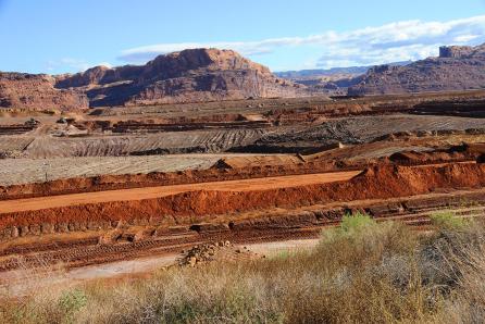 The most waste in the nuclear power industry is generated by uranium ore mining and its processing. This is primarily the separated spoils and sludge pools. The heaps are not considered to be radioactive waste. (Source: © Gary Whitton / stock.adobe.com)