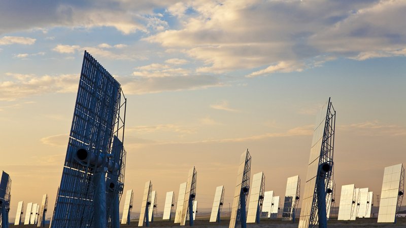 A field of mirrors — heliostats ready to reflect the first sunbeams of the day at the top of the tower. (Source: © Darren Baker / stock.adobe.com)