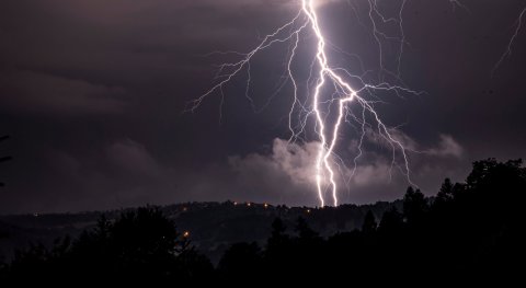What happens to lightning (energy) when it goes down a lightning rod to the ground?