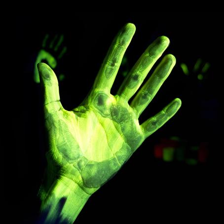 Fluorescent image of a right hand illuminated by UV radiation. Henri Becquerel also experimented with a similar type of luminescence when he placed illuminated minerals on a photographic plate. (Source: © devmarya / stock.adobe.com)