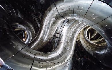 Interior of the Large Helical Device (LHD), showing the strongly twisted plasma vessel characteristic of helical stellarator geometry. (Credit: Wikimedia Commons)