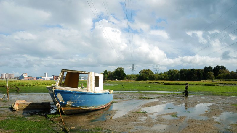 An old moored boat at low tide. Poole natural bay in Dorset, England. (Source: © Becky Stares / stock.adobe.com)