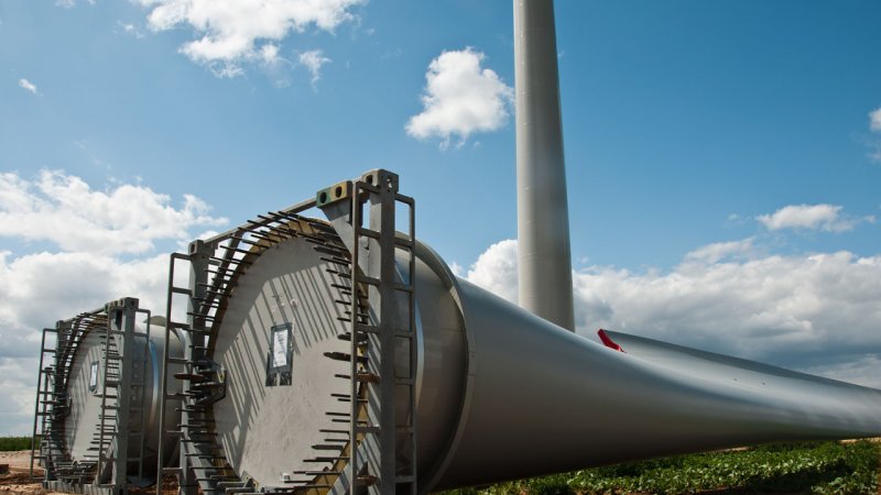 Blades of giant wind turbines, ready to be fitted. (Source: © pixarno / stock.adobe.com)