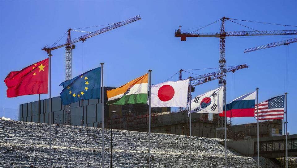 The flags of the seven ITER Members — China, the European Union, India, Japan, Korea, Russia, and the United States — fly over the worksite. (Credit © ITER Organization, http://www.iter.org/)